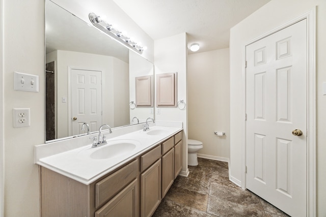 bathroom with toilet and vanity