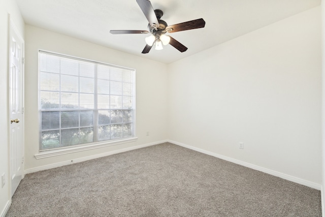 carpeted empty room featuring ceiling fan