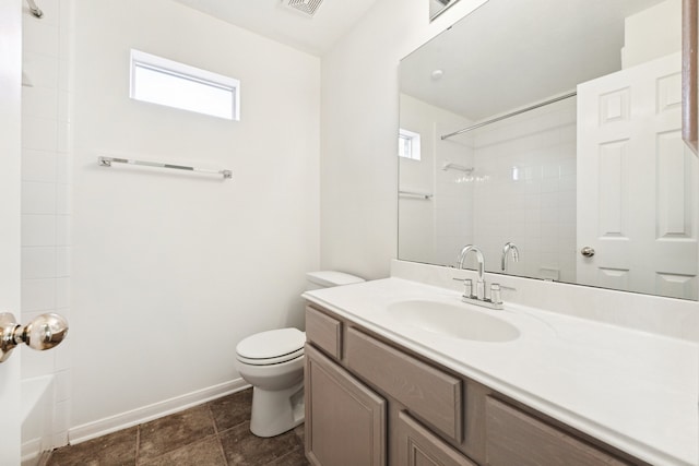 bathroom with toilet, walk in shower, and vanity