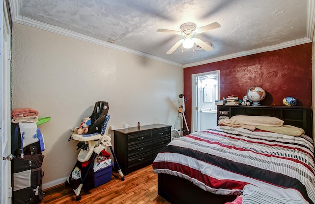 bedroom with hardwood / wood-style floors, crown molding, a textured ceiling, and ceiling fan