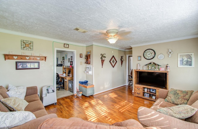 living room with crown molding, hardwood / wood-style floors, and a textured ceiling