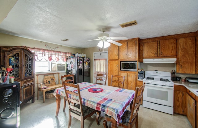 kitchen with stainless steel appliances, ceiling fan, and a textured ceiling