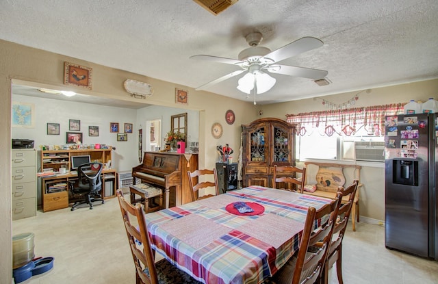 dining area with a textured ceiling and ceiling fan