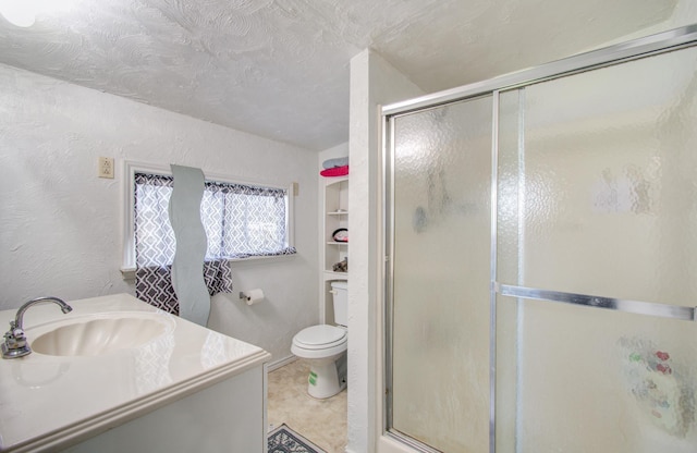 bathroom with a shower with door, tile patterned flooring, vanity, a textured ceiling, and toilet