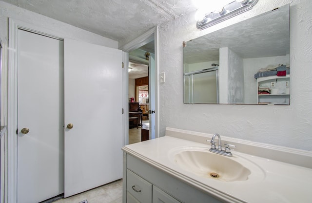 bathroom with vanity and an enclosed shower