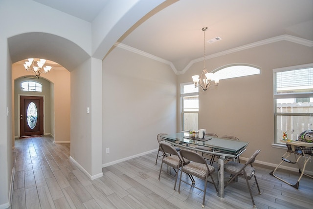 dining space with an inviting chandelier, light hardwood / wood-style flooring, and a wealth of natural light