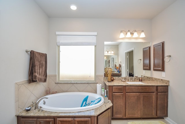 bathroom with vanity and a bath