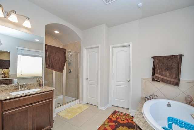 bathroom with tile patterned floors, vanity, and independent shower and bath