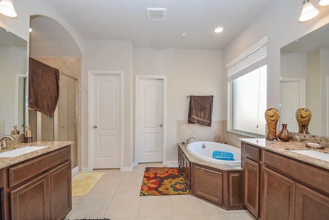 bathroom with tile patterned floors, vanity, and independent shower and bath