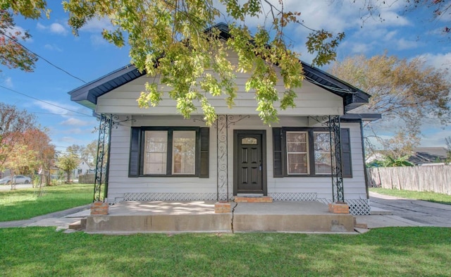 bungalow-style house featuring a porch and a front yard