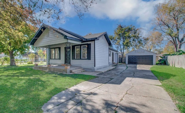 view of front of home featuring covered porch, a garage, a front lawn, and an outdoor structure