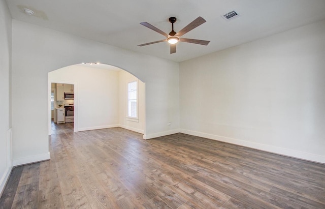 empty room with hardwood / wood-style floors and ceiling fan