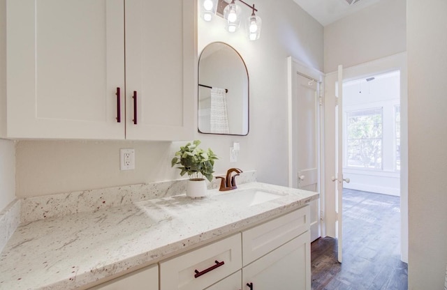 bathroom with hardwood / wood-style floors and vanity