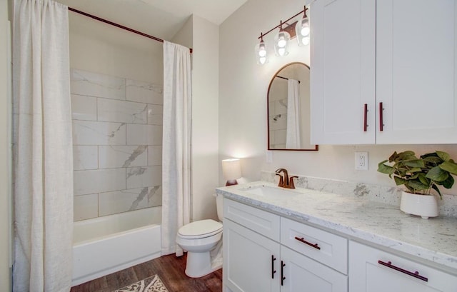 full bathroom with vanity, toilet, wood-type flooring, and shower / tub combo