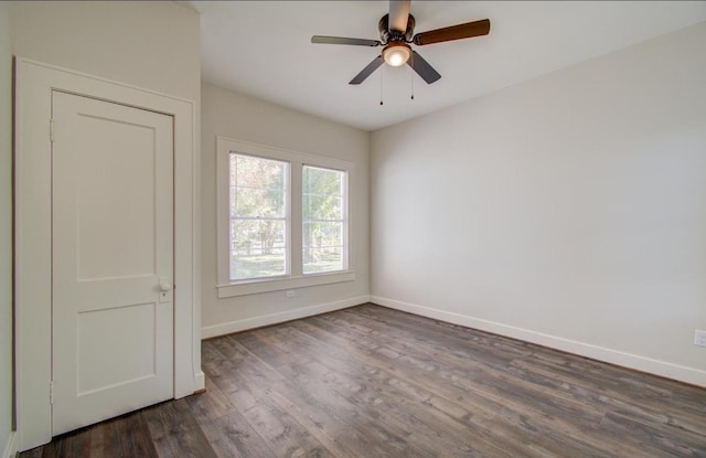 unfurnished room featuring dark hardwood / wood-style floors and ceiling fan