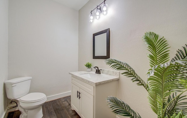 bathroom featuring hardwood / wood-style floors, vanity, and toilet