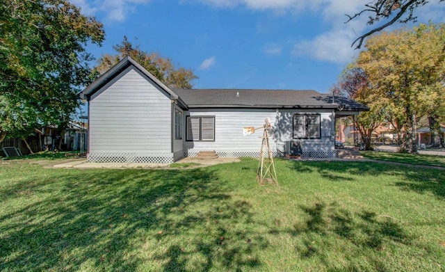 rear view of property with a lawn