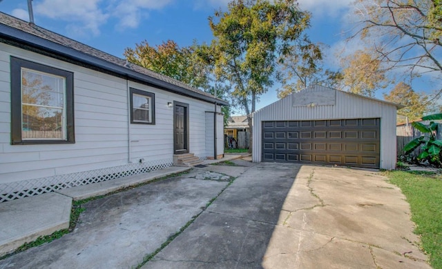 view of side of property featuring a garage and an outdoor structure