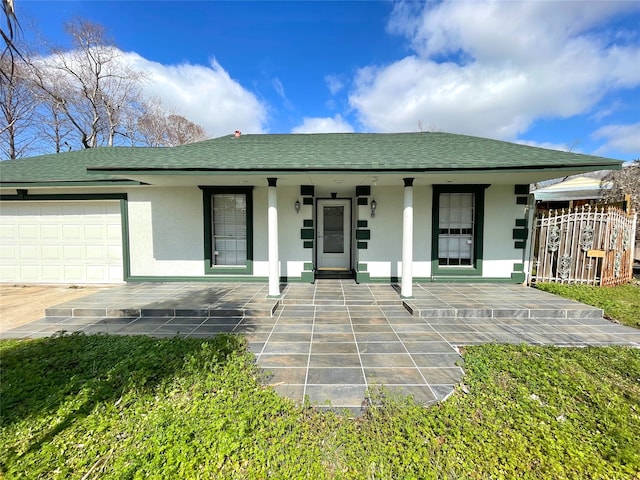 view of front of home featuring a porch and a garage