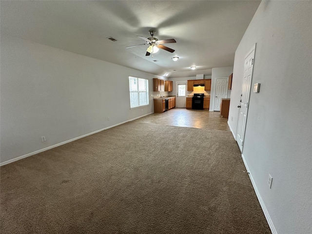 unfurnished living room featuring ceiling fan and light colored carpet