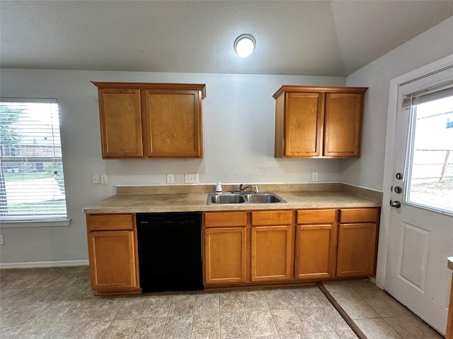 kitchen featuring sink, lofted ceiling, black dishwasher, and a wealth of natural light