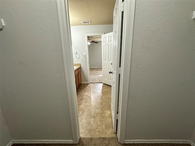 hall with light tile patterned floors