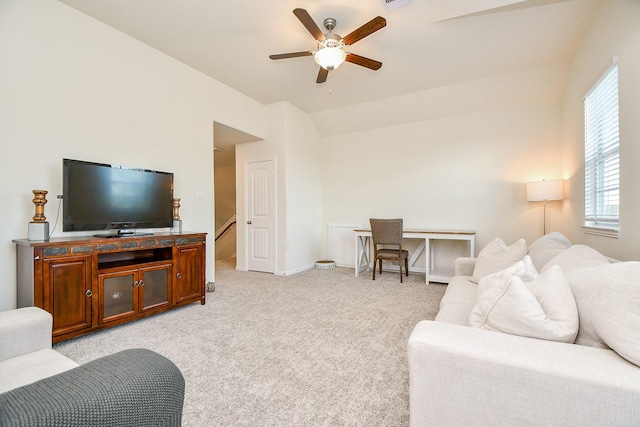 living room featuring light colored carpet, ceiling fan, and lofted ceiling