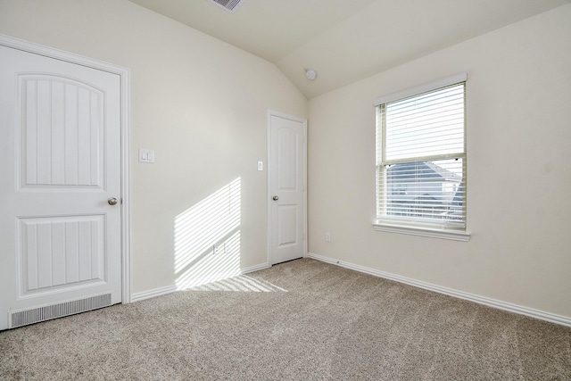 unfurnished room with light carpet and lofted ceiling