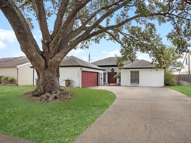 single story home with a garage and a front lawn