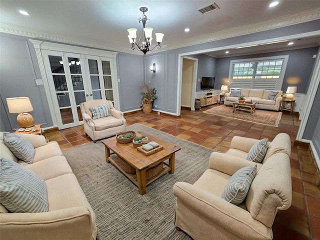 tiled living room with a notable chandelier, crown molding, and french doors