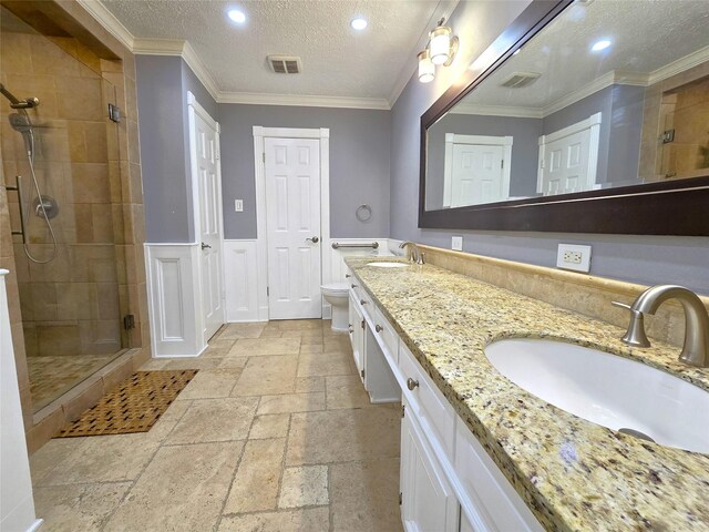 bathroom with a shower with shower door, toilet, ornamental molding, and a textured ceiling