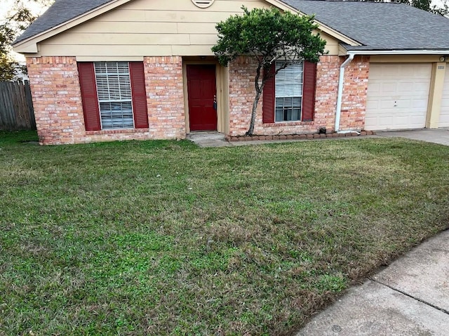 ranch-style home featuring a garage and a front lawn