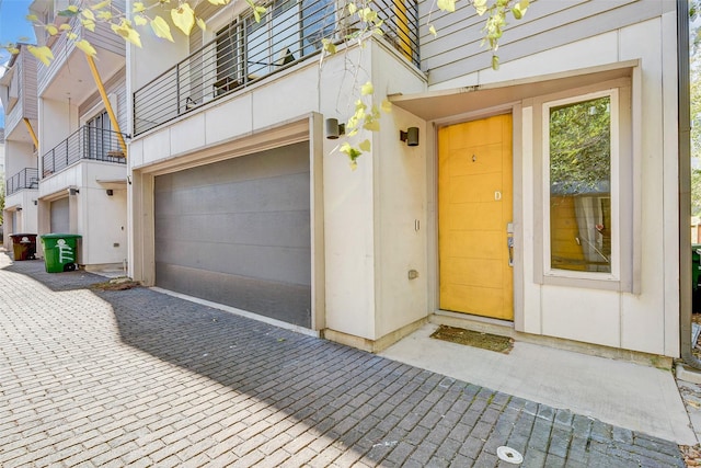 doorway to property with a garage