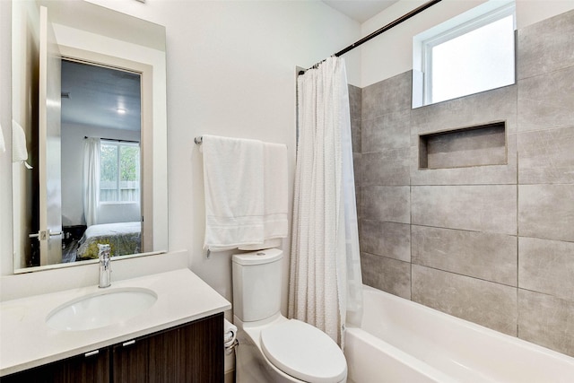 full bathroom featuring shower / tub combo, vanity, and toilet