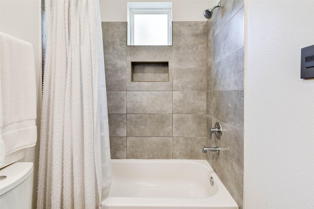 bathroom featuring toilet and shower / bath combo with shower curtain