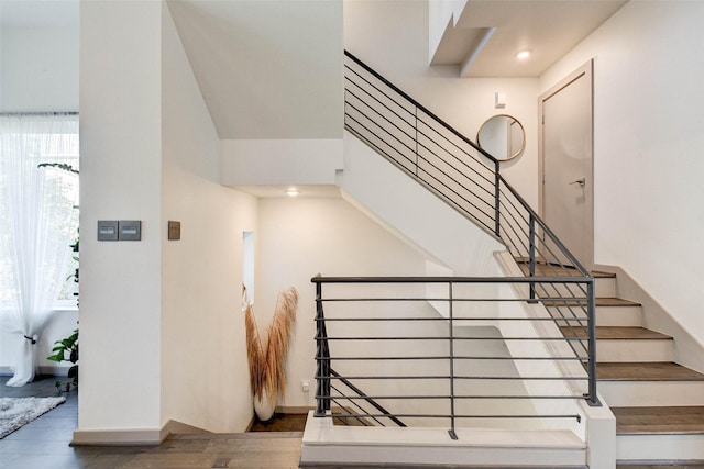 stairway with hardwood / wood-style floors