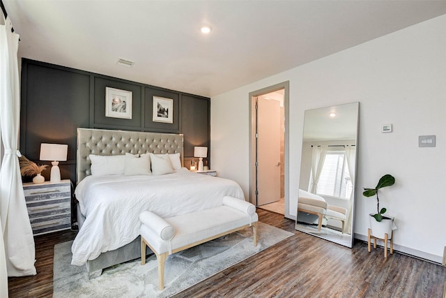 bedroom with dark hardwood / wood-style floors