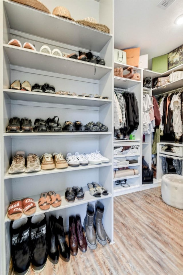 walk in closet featuring hardwood / wood-style floors