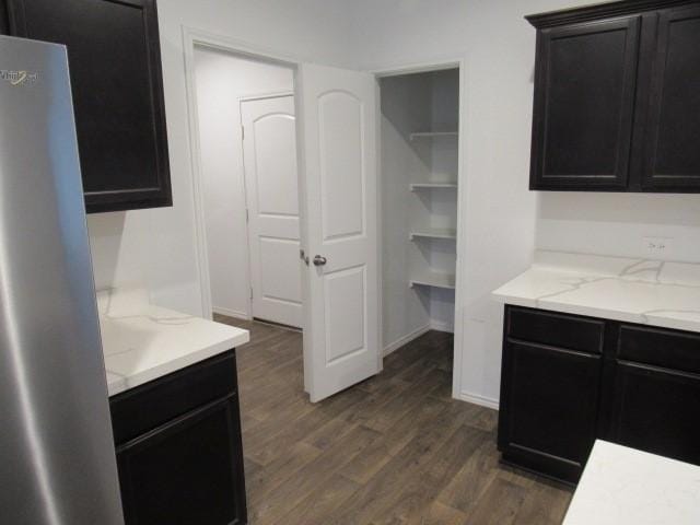 kitchen featuring stainless steel fridge and dark hardwood / wood-style floors