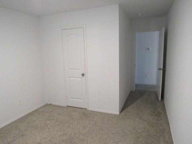 spare room featuring light colored carpet