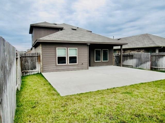 rear view of house featuring a patio and a lawn