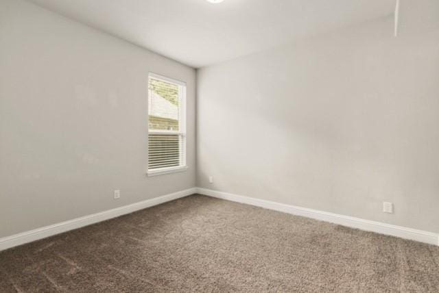 empty room with dark colored carpet