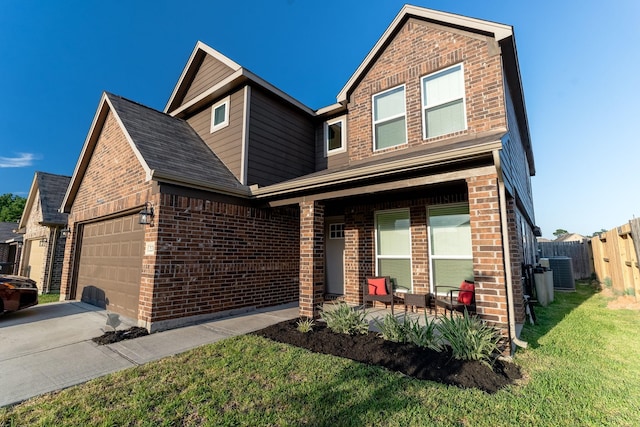 view of front of house with central air condition unit, a front yard, and a garage