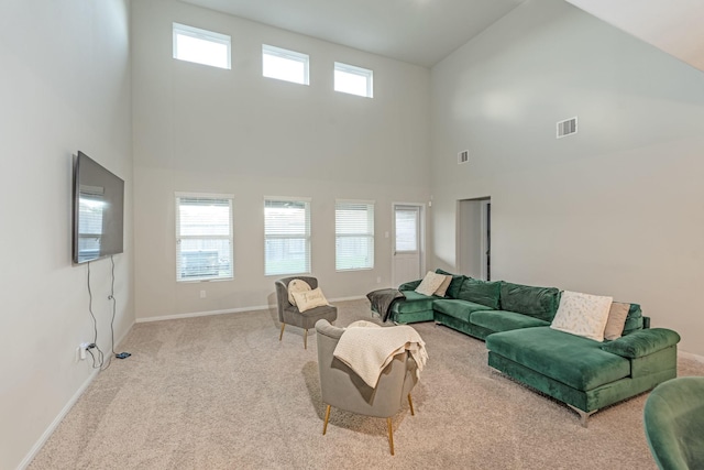 living room featuring light carpet and high vaulted ceiling