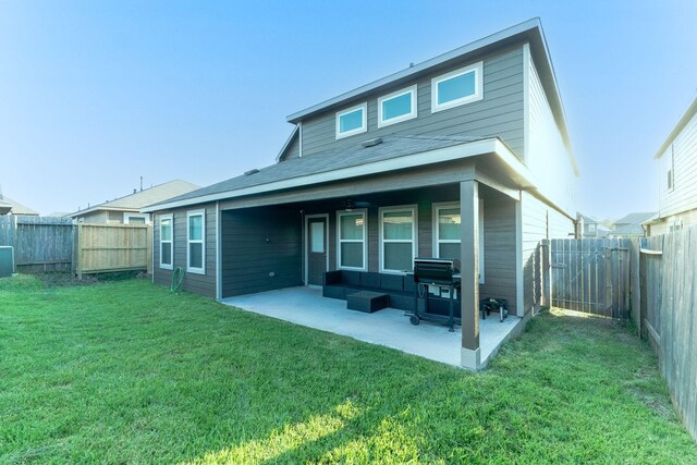 back of house with a yard and a patio