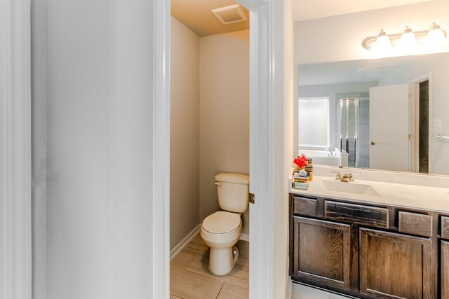 bathroom featuring vanity and toilet