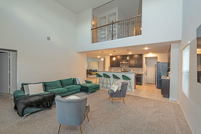 living room with light carpet and a high ceiling