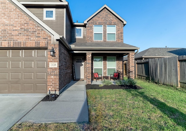 view of front of property with a front yard and a garage