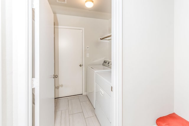 clothes washing area featuring washer and clothes dryer