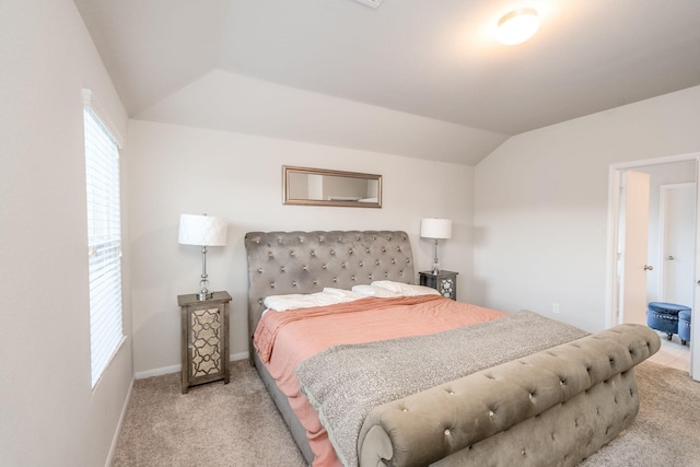 bedroom with light colored carpet and vaulted ceiling